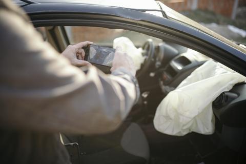 Car insurance agent at work investigating a crashed car