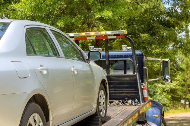 Gray car being towed